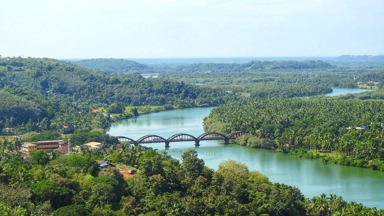 The Kuppam river near Taliparamba, with green hills and an arched bridge